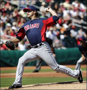 Cleveland Indians starting pitcher David Huff throws during the first inning of a spring training baseball game against the Cincinnati Reds in Goodyear, Ariz., Saturday.