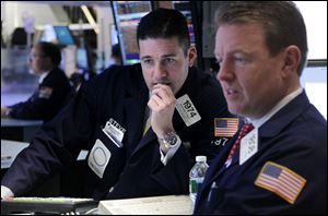 Traders work on the floor at the New York Stock Exchange in New York on Tuesday, as Dow Jones industrial average plunged 203 points, the worst drop in 2012. 