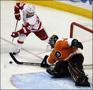 Philadelphia Flyers goalie Ilya Bryzgalov (30), from Russia, blocks a shot by Detroit Red Wings left wing Jiri Hudler (26), from the Czech Repbulic, in the third period of an NHL hockey game Tuesday in Philadelphia. The Flyers won 3-2.