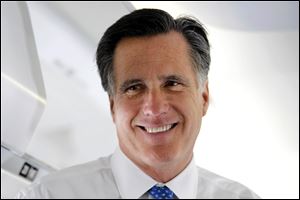 Republican presidential candidate, former Massachusetts Gov. Mitt Romney talks to reporters on his campaign plane before taking off for Boston.