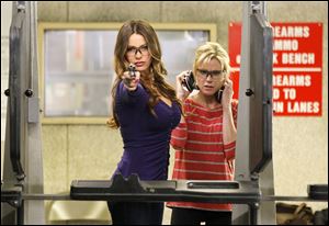 Sofia Vergara, left, and Julie Bowen are shown in a scene from a an episode of ‘Modern Family.’ Vergara plays Gloria Pritchett, who is stepmother to Bowen’s Claire Dunphy.