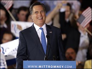Republican presidential candidate, former Massachusetts Gov. Mitt Romney smiles as he addresses supporters at his Super Tuesday campaign rally in Boston.