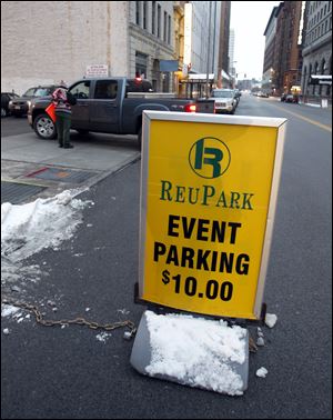Parking in the lot next to a downtown restaurant was $10 before a Toledo Walleye game last year.