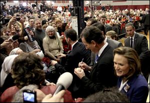 Rick Santorum signs a baseball after speaking at an election-night party at Steubenville High School in eastern Ohio, near the West Virginia and Pennsylvania state lines.