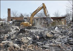 Crews work to demolish Beverly Elementary School in South Toledo last month. The city of Toledo is interested in buying the property for residential use, Deputy Mayor Tom Crothers said.
