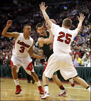 Toledo Central Catholic's Drew Lehman (20) is pressured by LaSalle's Josh Lemons (3) and Ryan Fleming (3) during the second half of the 2011 State Boys Division I basketball semifinal. LaSalle won 48-46. 