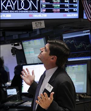 A New York Stock Exchange trader watches prices fall. Tuesday's plunge started with the opening bell. 