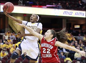 University of Toledo Rocket's Andola Dortch takes the ball to the hoop against Northern Illinois' Amanda Carrol at Quicken Loans Arena.