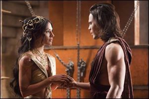 Lynn Collins portrays Dejah Thoris, left, and Taylor Kitsch portrays John Carter in a scene from the new Disney film.
