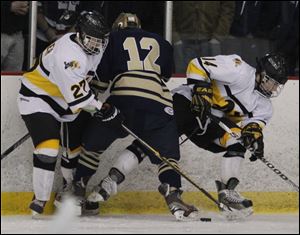 Northview's Zach Felser, left, and Kooper Carter battle for the puck against Austin Kelly of St. John's Jesuit in the District final.