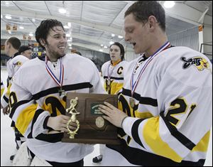 Northview goaltender Austin Gryca, left, and Brady Storer hold the district championship trophy after the Wildcats defeated St. John's.