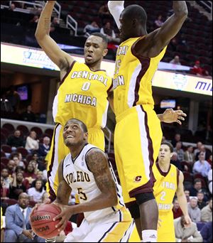 Toledo's Rian Pearson looks to score against Central Michigan's Trey Zeigler, left, and Oliver Mbaigoto in Wednesday's Mid-American Conference tournament second-round game in Cleveland.
