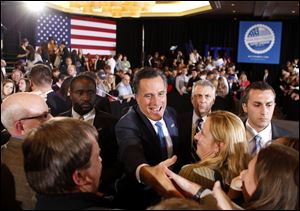 Republican presidential candidate, former Massachusetts Gov. Mitt Romney, greets supporters at his Super Tuesday primary party in Boston. The unofficial Ohio tally showed that fewer than 11,000 votes separated Romney from his main rival Santorum.
