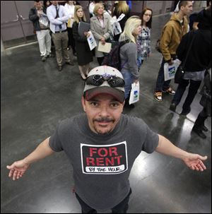 Don Bockmon, of Vancouver, wears his for rent T-shirt as other job seekers stand line during the recent Career Expo job fair in Portland, Ore.