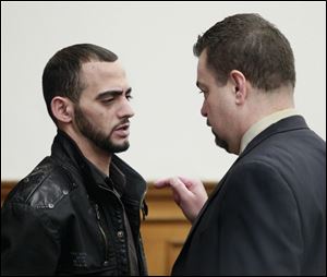 Bandar Abu-Karsh, left, confers with defense attorney John McMahon after his arraignment on an voluntary manslaughter charge.