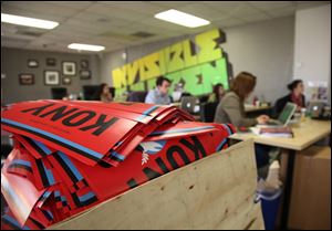 A box full to the brim with KONY 2012 campaign posters sit at the Invisible Children Movement offices in San Diego. The workers are monitoring the social media impact of their KONY 2012 campaign. 