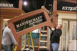 From left, Joe Baumann, Tiege Druckery, and Jake Wagner of Midwest Manufacturing put together the Mastercraft display. The show is to feature more than 175 exhibits covering about 75,000 square feet.