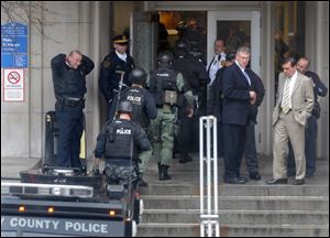 Police walk through the main entrance to Western Psychiatric Institute. Pittsburgh Mayor Luke Ravenstahl praised the public safety employees as well as the institute's staff.