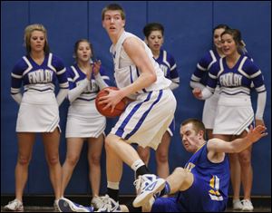 Anthony Wayne's Grant Fiock knocks over Findlay's Adam Twining during a Division I district semifinal game.
