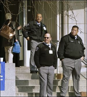 Security guards keep watch Fridayat the front entrance to the Western Psychiatric Institute and Clinic on the University of Pittsburgh campus.