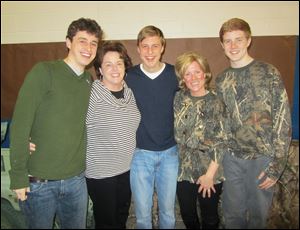 Ann Filipiak, second from left, with sons Charles, left, and Louis, center, and Jane Manahan, second from right, with son Tom, enjoy St. Francis de Sales' Mother-Son Dance.