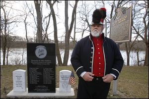 Historian Richard Rozevink, in battle regalia, pauses near the Fort Starvation marker at Independence Dam State Park in Defiance. Remains were found during construction of the Miami and Erie Canal, which opened in 1845.