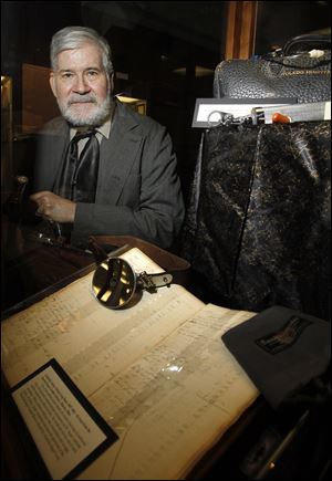 John Jaeger, dressed as his great great grandfather, Frederick Jaeger, sits with a log book that belonged to the circuit-riding doctor in Woodville who practiced until the 1860s. 