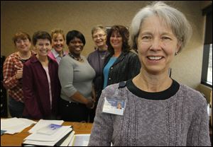 Dr. Pam Oatis, foreground, celebrates her award with members of her palliative care team. From left, they are Nicole Cassidy, Sister Cecile Sakaley, nurse Joyce Roe, Tammy McKittrick. Estil Canterbury, and Meliss Klorer.
