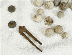 These artifacts, which include buttons, a fork, and musket balls, were found around Fort Meigs by Douglas Pratt.