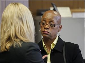 Gloria Burks confers with attorney Jane Roman, left, in Lucas County Common Pleas Court in Toledo, Wednesday, March 14, 2012. Burks is on trial for shooting fellow Sgt. Jeff Bechtel at the Scott Park police station.