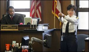 Deputy Chief Diana Ruiz-Krause demonstrates how Sgt. Gloria Burks pointed a gun at her in a 