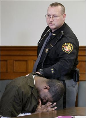 Thomas Johnson becomes emotional after receiving a sentence of 17 years in prison for his role in the slaying of Charles Harris, 71.