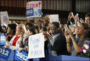 Audience members cheer and hold up reelection campaign signs during Vice President Joe Biden's appearance.