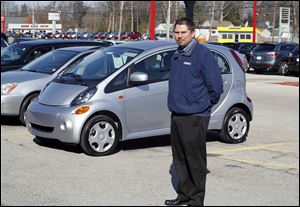 Archie Mead, sales manager at the Brown dealership on Central Avenue, shows off its first i-MiEV. It carries a federal income tax credit. 