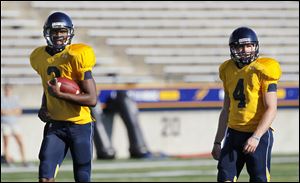University of Toledo quarterbacks Terrance Owens, left, and Austin Dantin, seen here in an August, 2011, practice, are again in a battle for the lead.