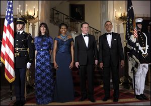 President Barack Obama and first lady Michelle Obama pose for an official photo with British Prime Minister David Cameron and his wife, Samantha Cameron, at the White House before the state dinner. 