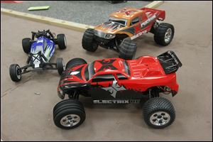 From left to right:  Boost Buggy, Ruckus Monster Truck, back, Circuit Stadium Truck, front, at HobbyTown USA. Pieces from remote control cars like these were used to create the bomb that blew up under Erik Chappell's Volvo.