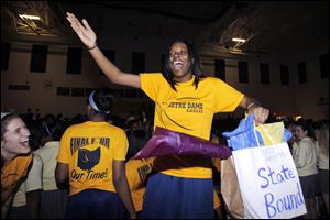 Sophomore guard Talajha Parker celebrates with other students during Thursday's pep rally in the gym at Notre Dame Academy. The all-girls Catholic high school plays at 6 p.m. Friday in Columbus.
