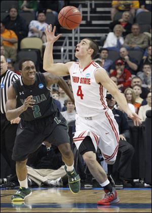 Ohio State's Aaron Craft (4) gets control of the ball in front of Loyola of Maryland's Justin Drummond (2) in the first half Thursday night's game.