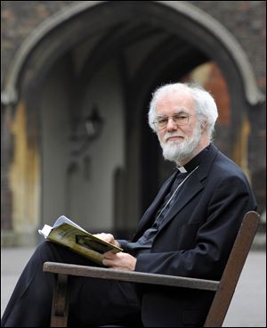 Archbishop of Canterbury Rowan Williams reads the Book of Common Prayer on Friday on the grounds of Lambeth Palace, London.