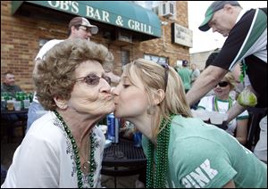 Melissa Gunner of Toledo gives her grandmother Gwen Gunner, 84, of Lambertville a kiss at OB's Tavern in West Toledo on St. Patrick's Day.