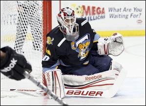 Toledo Walleye goalie Carter Hutton, 30, keeps an eye on the action against the Cincinnati Cyclones during the second period, Friday, November 25, 2011. 