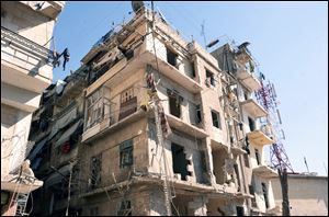 This photo released by the Syrian official news agency SANA shows a damaged building after a blast in Aleppo, Syria.