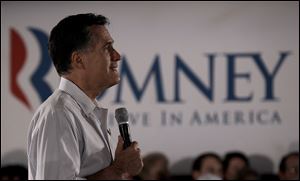 Republican presidential candidate, former Massachusetts Gov. Mitt Romney listens to a question during a campaign stop Saturday in Collinsville, Ill.