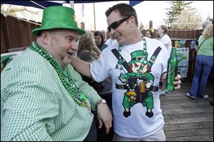 Paul Gunner, left, jokes with his nephew Charlie Hendley of Belleville, Mich., as the extended Gunner family reunite for their 45th straight year at OB's Bar & Grill. Mr. Gunner has been spending St. Patrick's Day at the bar since he was old enough to drink beer. 