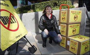 Katy Butler, 17, an Ann Arbor high school student, shows petitions she took to the Motion Picture Association of America, Los Angeles. She says the movie ‘Bully’ could create a change among youth if they were allowed to see it.