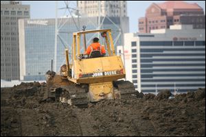 Dredged material from the Maumee River and Lake Erie is filling in land along the bank. Plantings to soak up pollutants are to follow.