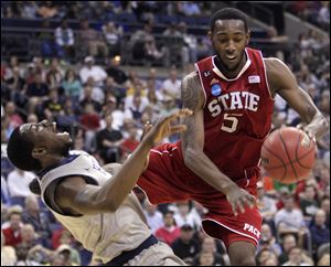 North Carolina State's C.J. Leslie, right, collides with Georgetown's Henry Sims during the second half of an NCAA college basketball tournament third-round game Sunday in Columbus. NC State defeated Georgetown 66-63. 