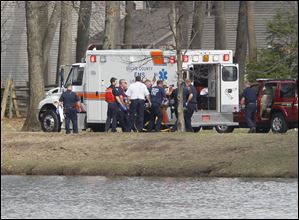 Rescue personnel move a woman's body to an ambulance at Olander Park in Sylvania.