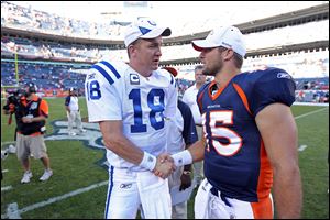 Peyton Manning, left, is negotiating to join the Broncos, ESPN reported Monday, which could lead to the ouster of quarterback Tim Tebow, right.